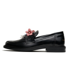 Side profile of a black patent-finish Filling Pieces loafer with a pink leather flower bouquet on the penny strap and a low stacked heel.