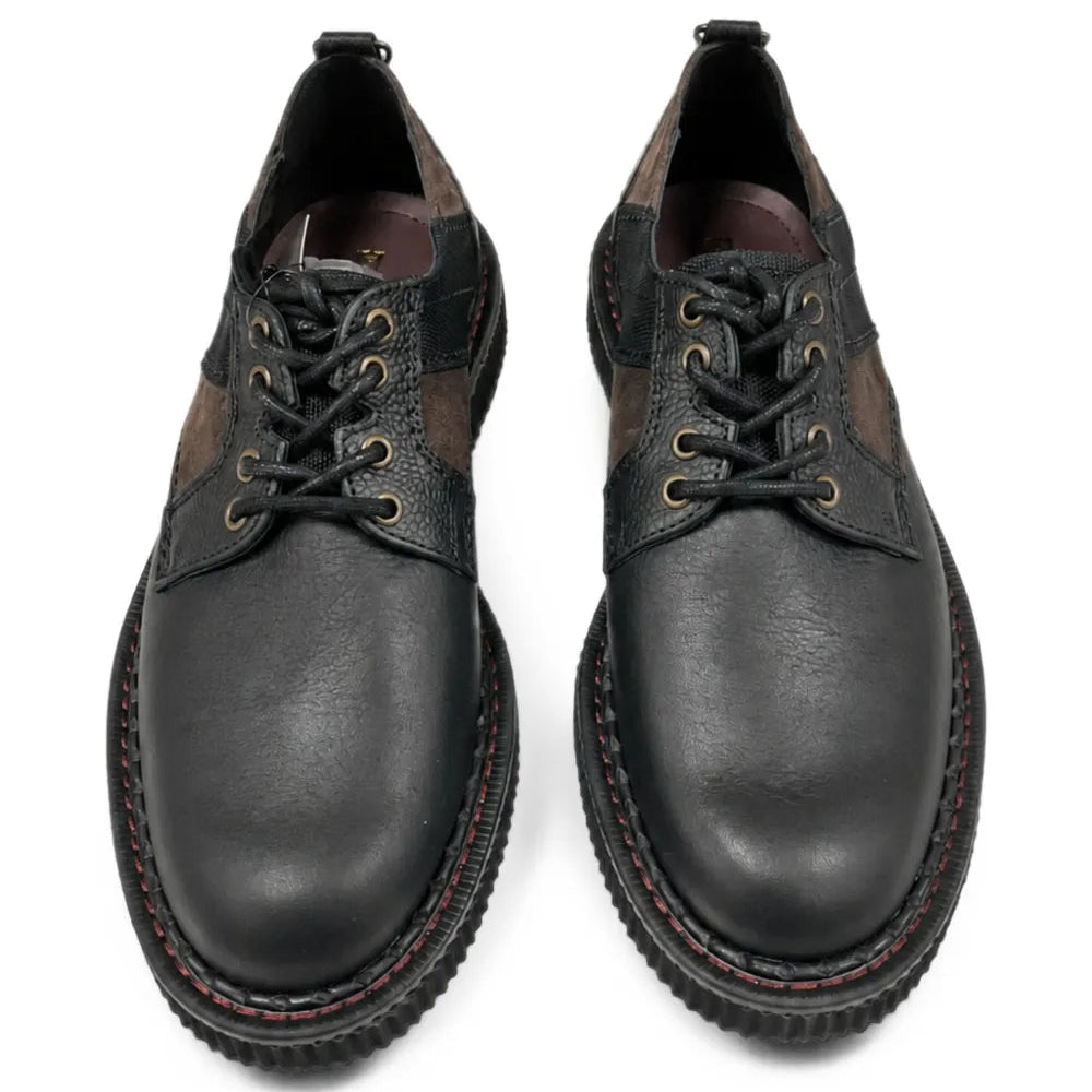 Top-down view of the pair, showing the lace-up fronts with brass eyelets, the patchwork upper and the red contrast stitching on the welt.