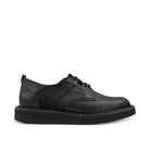 A black leather lace-up shoe with a textured panel on the side and a thick, ribbed black sole, shown from a side profile against a plain white background.