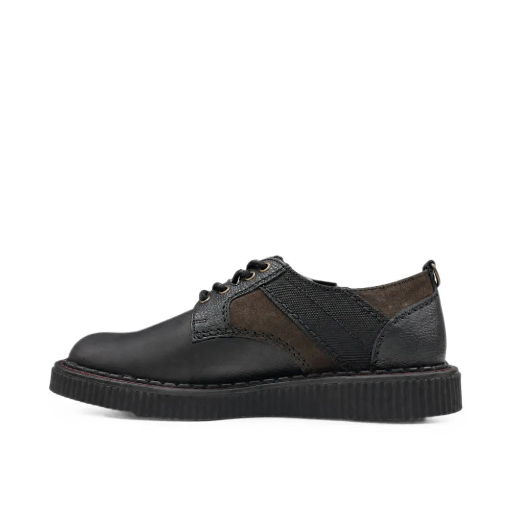 A black leather lace-up shoe with dark brown suede side panels and a chunky black sole, shown in profile against a plain white background.