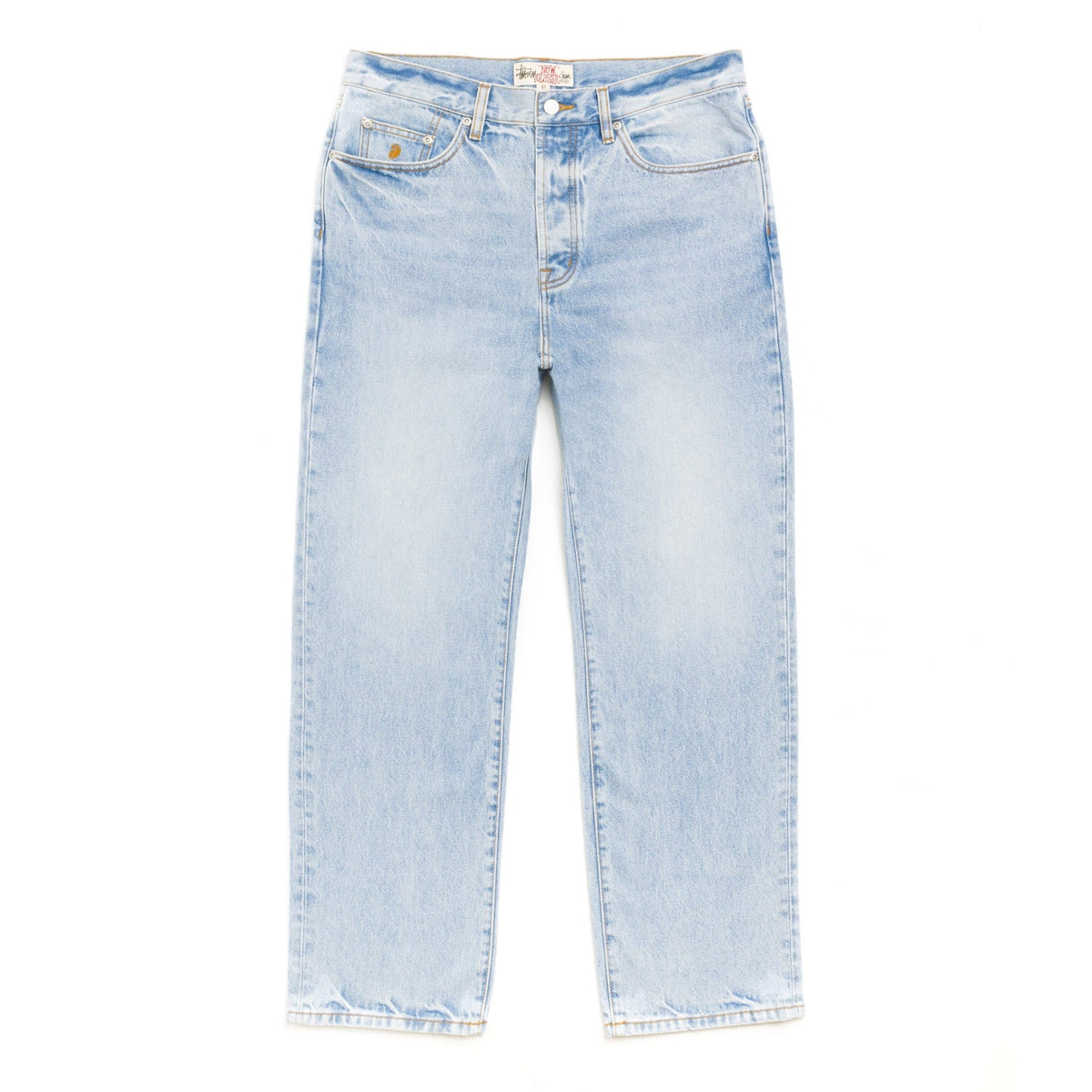 Front view of the Stüssy New Classic Jean in light wash indigo laid flat. Pale blue straight-leg jeans with fading, gold stitching, a button fly and a small embroidered logo on the coin pocket.