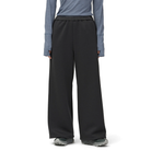 Model wearing charcoal Snow Peak Odor Control Women’s Pants with a blue-grey long-sleeve top and grey trail shoes, showing the relaxed wide-leg fit.