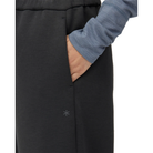 Close-up of a hand in the side pocket of charcoal Snow Peak Odor Control Women’s Pants, with the small Snow Peak logo printed on the hip.