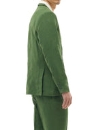 Man wearing a green suit against a white background
