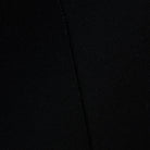 Close-up of a black textured fabric with a visible seam running vertically.