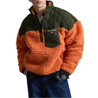 A model wears the orange and olive Polo Sport Pullover with dark jeans, hands in his pockets.
