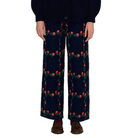 Model wearing The Tiny Big Sister Roses Grid Embroidery Berta Long Jeans with a navy knit cardigan and brown tasseled loafers, showing the wide-leg fit.