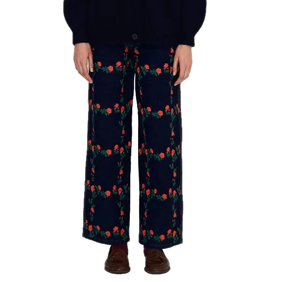 Model wearing The Tiny Big Sister Roses Grid Embroidery Berta Long Jeans with a navy knit cardigan and brown tasseled loafers, showing the wide-leg fit.