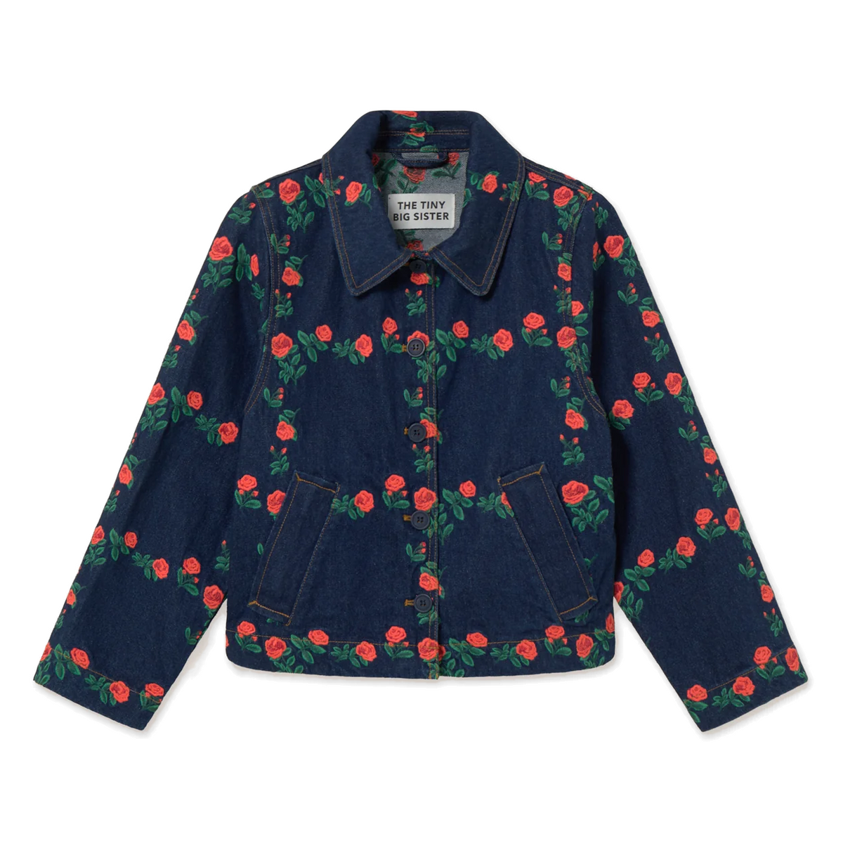 Front view of The Tiny Big Sister Roses Grid Embroidery Denim Jacket laid flat on white, showing the dark-wash denim embroidered with red roses in a grid, the point collar, navy button front and angled welt pockets.