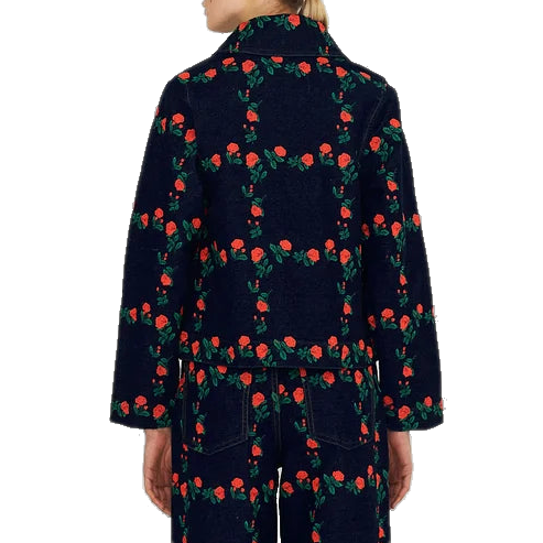 Back view of a model wearing The Tiny Big Sister Roses Grid Embroidery Denim Jacket with the matching jeans, showing the rose grid embroidery across the back.