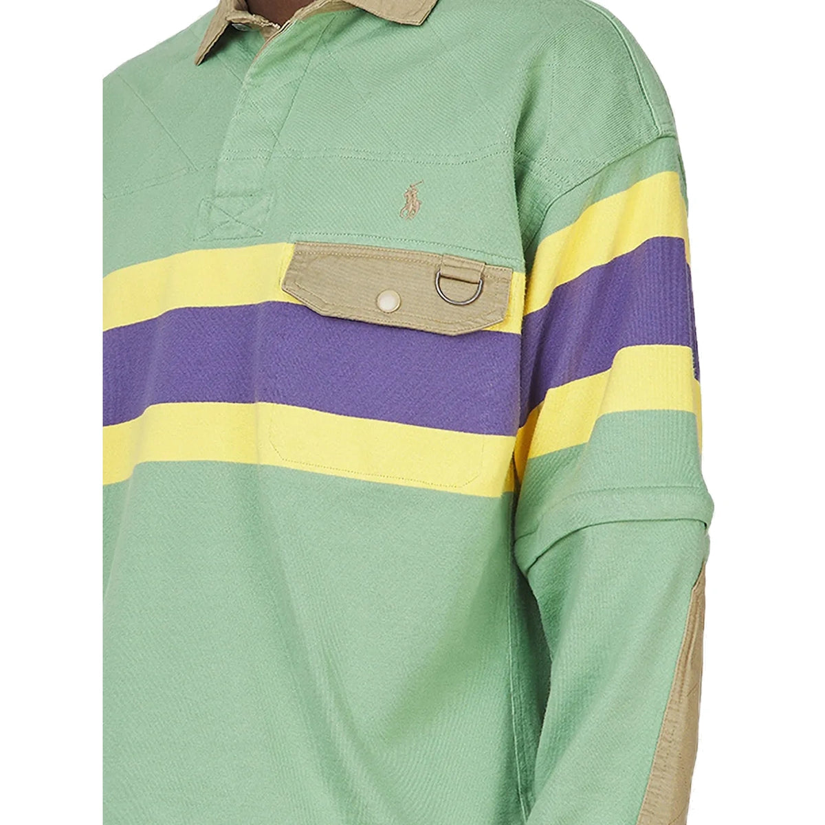 Close-up of the Rugby Polo Pullover on a model, showing the embroidered Pony, the quilted yoke, the khaki flap pocket with a D-ring, and a khaki elbow patch.