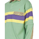 Close-up of the Rugby Polo Pullover on a model, showing the embroidered Pony, the quilted yoke, the khaki flap pocket with a D-ring, and a khaki elbow patch.