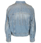 A light blue denim jacket shown from the back, featuring fringe detailing across the upper back and shoulders, and silver rhinestone embellishments on the shoulders and upper back.