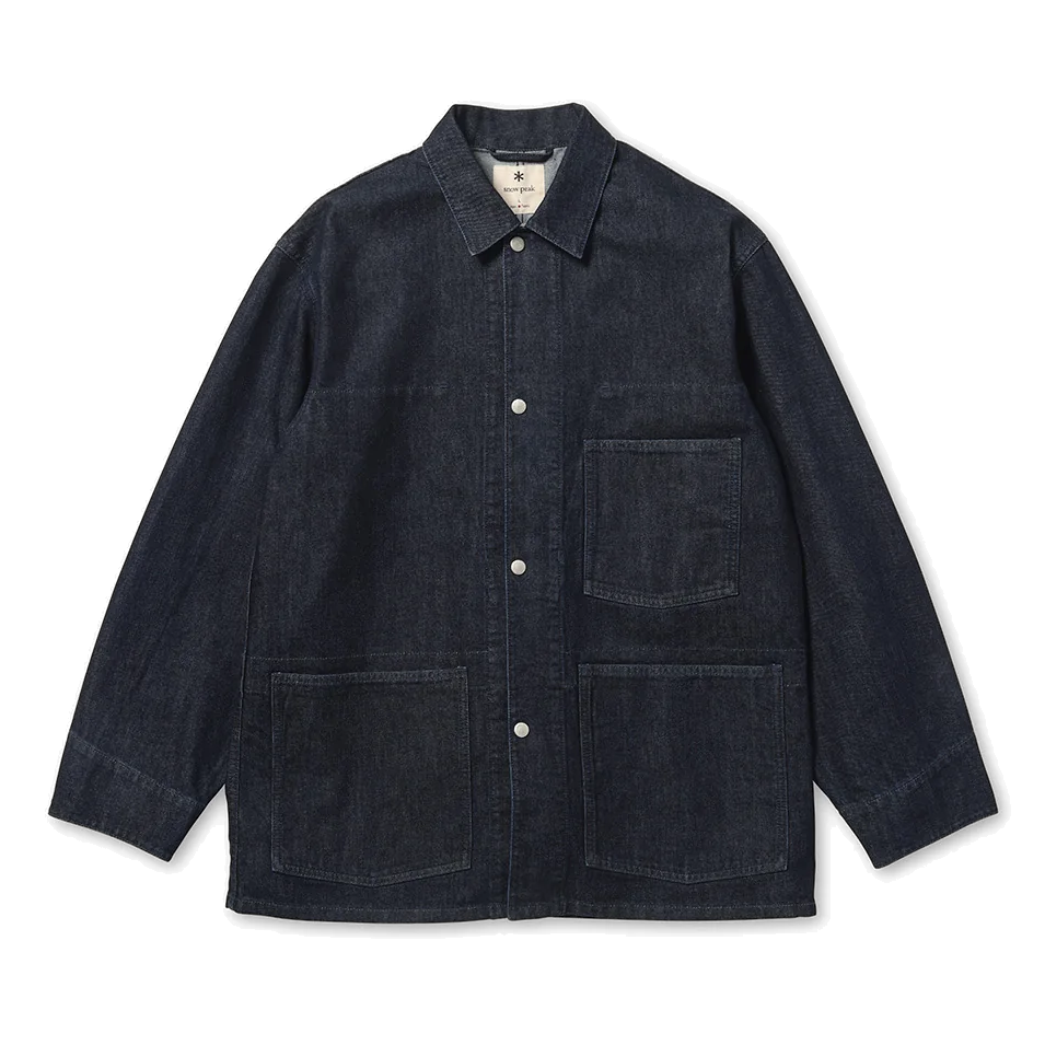 Front view of a Snow Peak Takibi Denim Jacket in dark indigo, laid flat on white, showing the collar, snap front, one chest patch pocket and two large lower patch pockets.
